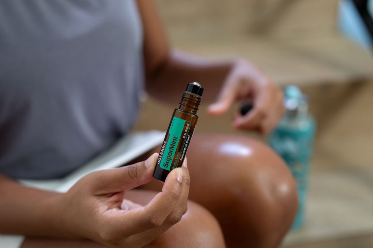Peppermint oil bottle on wooden surface