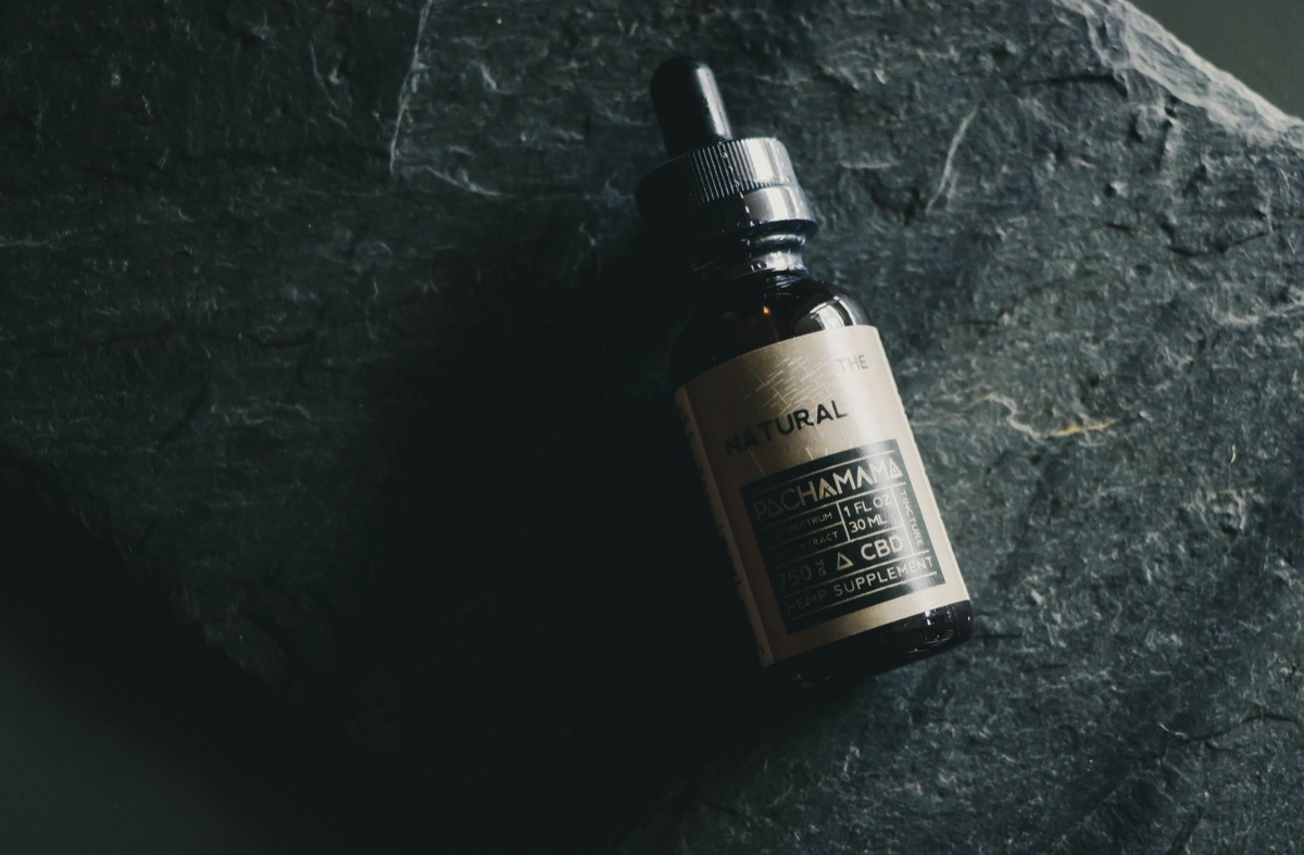 Modern herbal medicine bottle with a clear label and dried herbs inside
