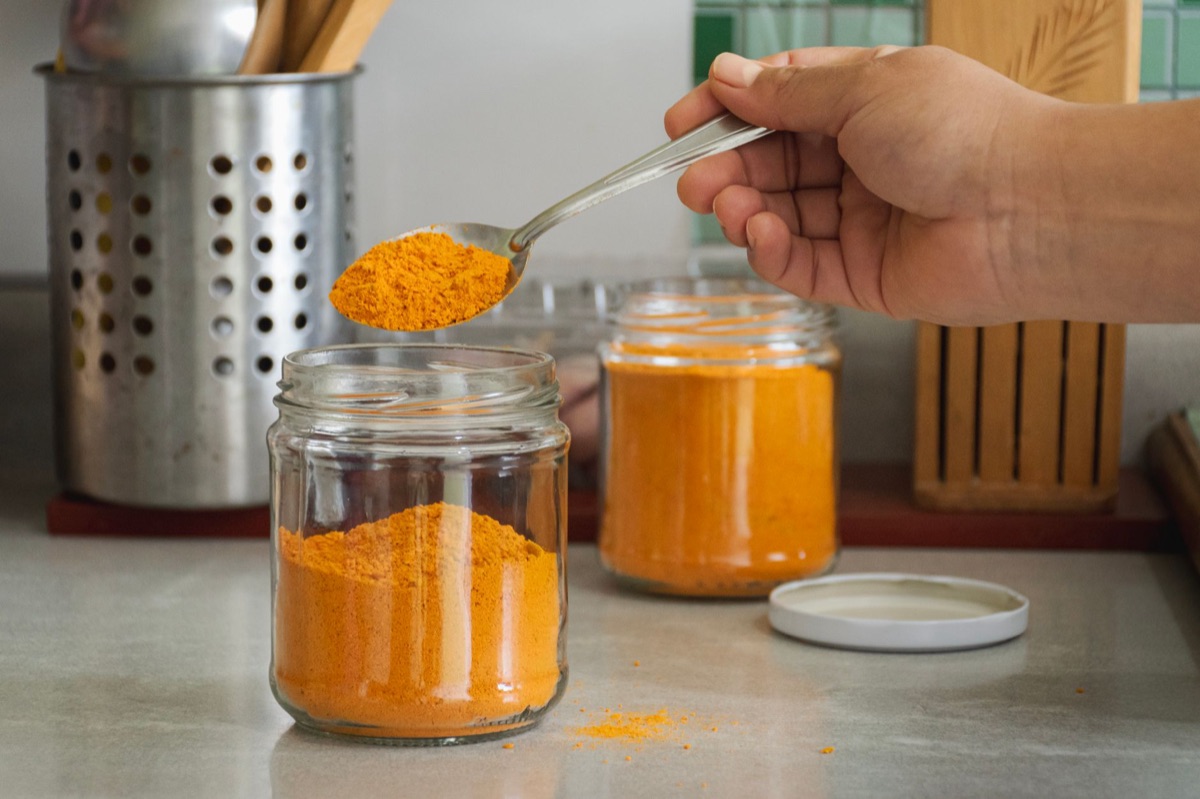 Turmeric root in a glass jar with soil