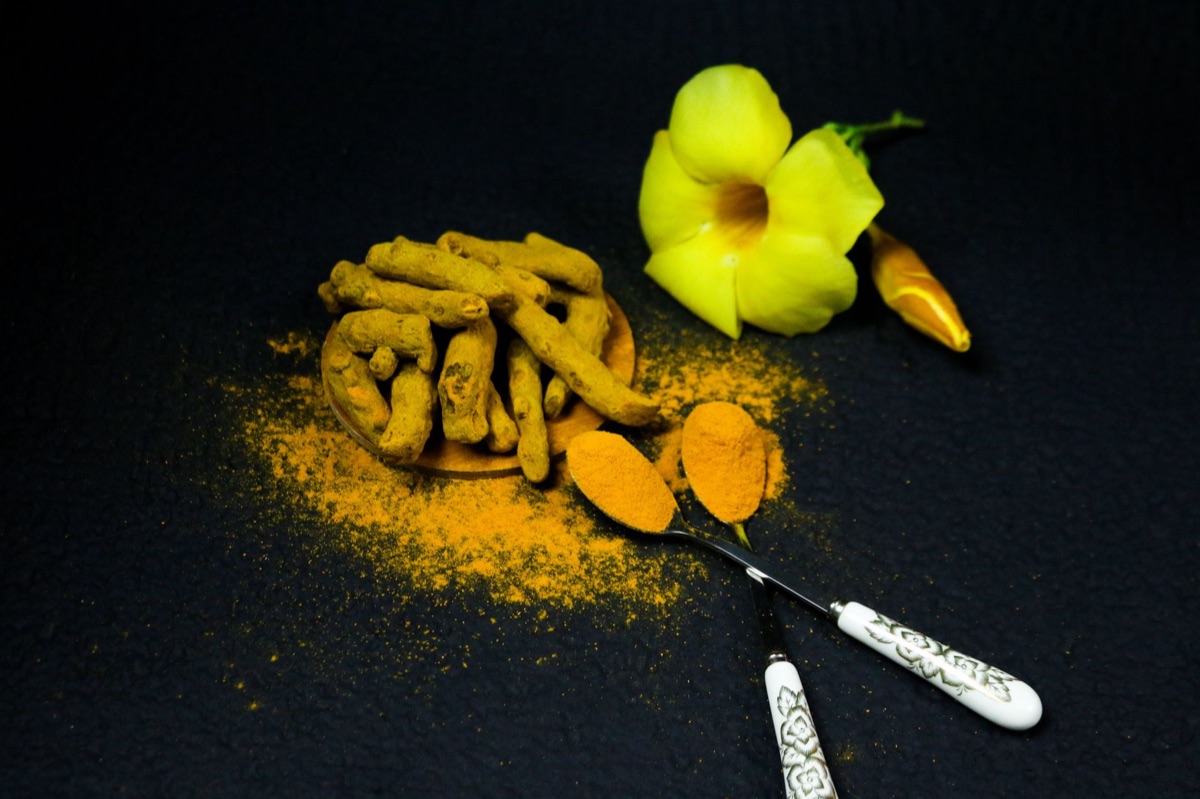 Racine de curcuma dans un sol blanc